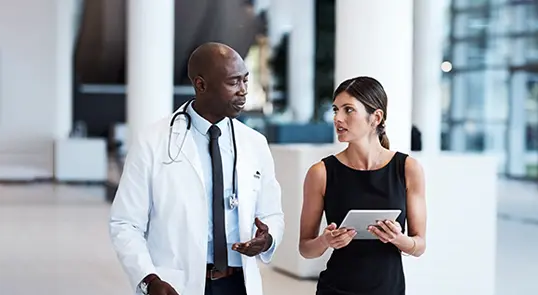 A doctor speaks with a Servier representative.