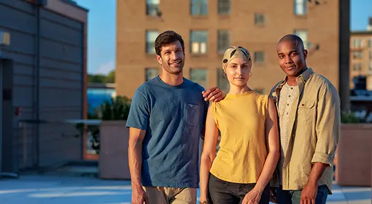Three acute lymphoblastic leukemia patients pose together and smile.