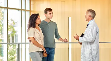An acute lymphoblastic leukemia patient and their partner meet with a doctor.